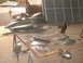 1994 Ford Bronco - Various car body parts are laid out on a workbench, possibly for repair or customization.